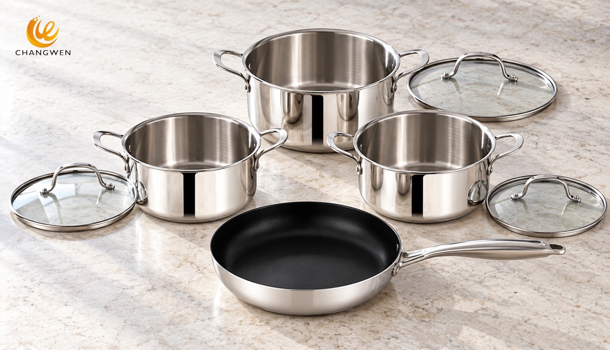 Three lidded stainless steel pots and a dark-interior frying pan arranged with glass lids removed to illustrate vessel and lid counts