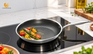 Illustrative honeycomb stainless steel frying pan with vegetables on an induction hob
