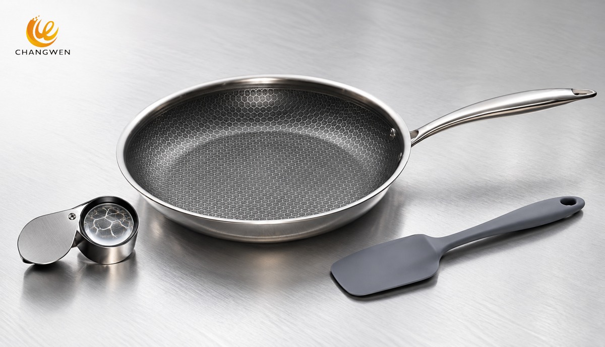 Illustration of a honeycomb frying pan beside a magnifying loupe and silicone spatula